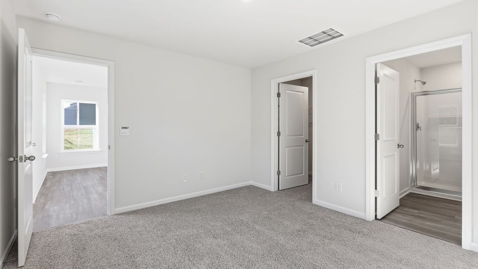 Bedroom with carpet and window.
