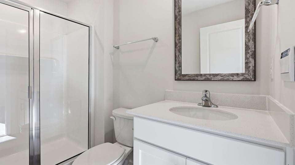 Bathroom with single vanity sink and walk in shower.