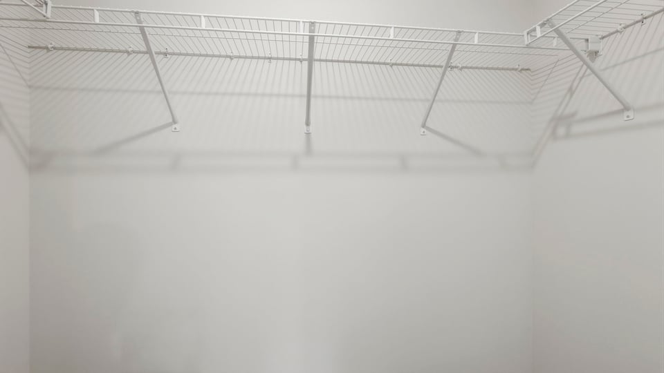 Closet with hanging storage racks.