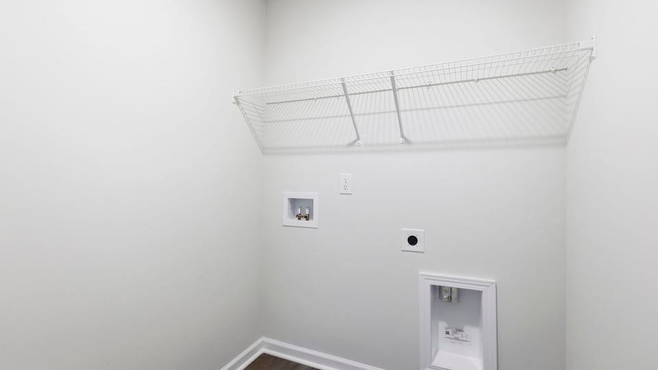 Laundry room with hanging storage racks.