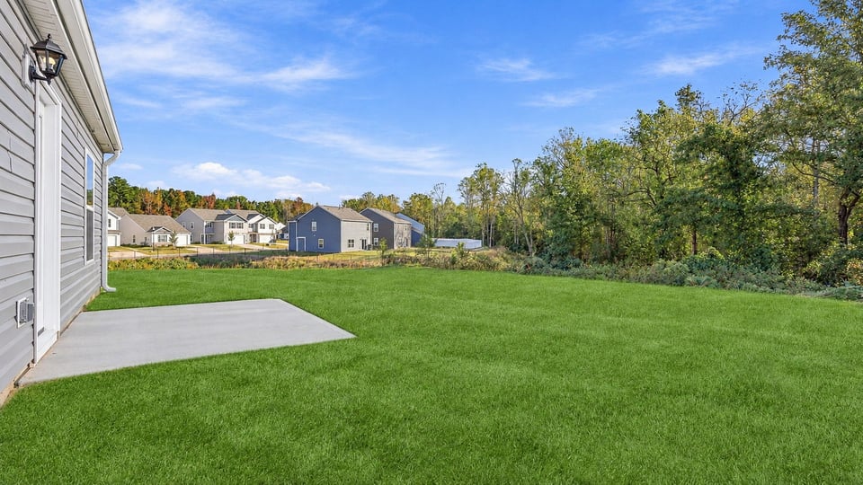 Back exterior of home with patio.
