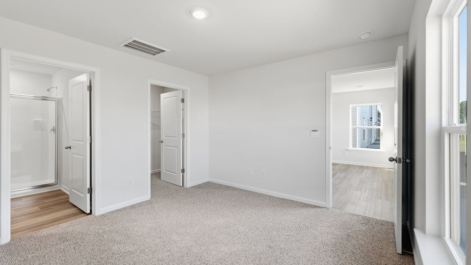 Bedroom with carpet and window.