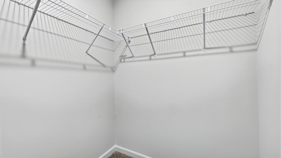 Closet with hanging storage racks.