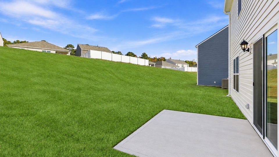 Back exterior of home with large backyard.
