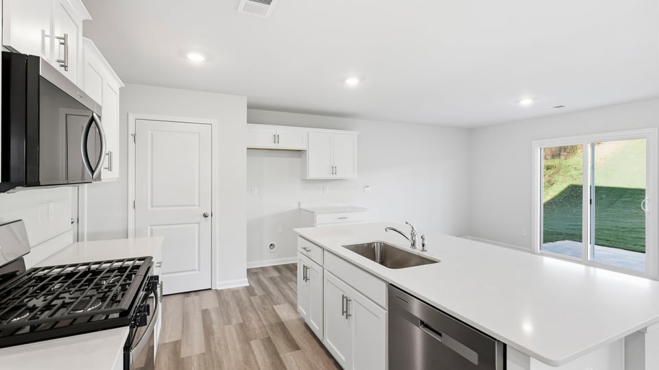 Kitchen and island with quartz countertops.