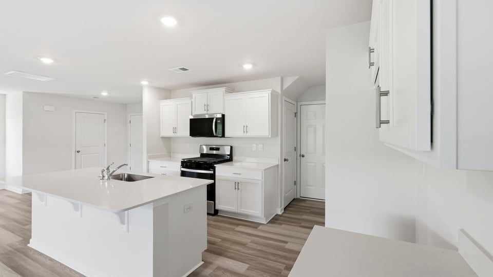 Kitchen and island with quartz countertops.