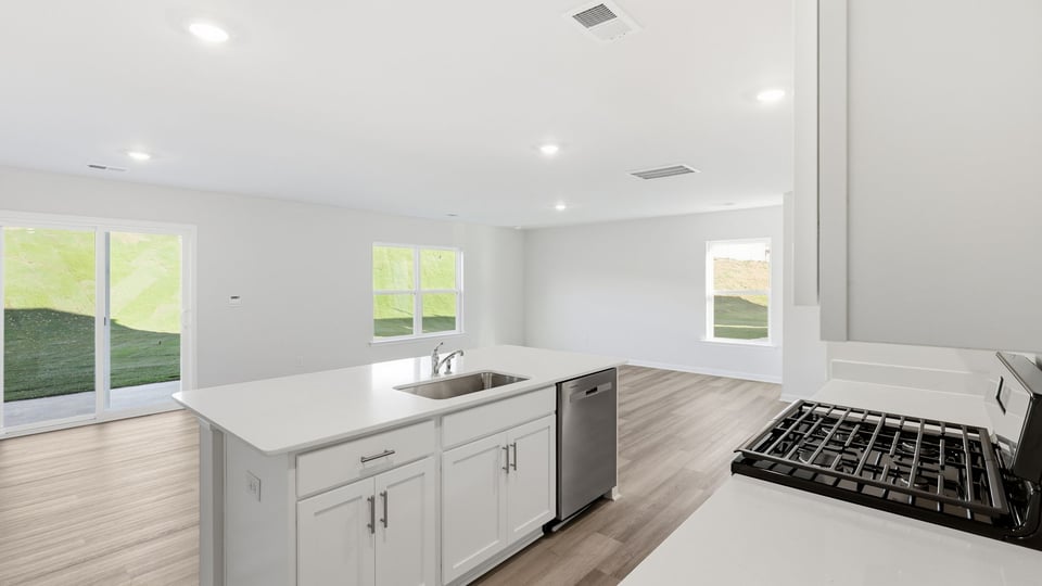 Kitchen and island with quartz countertops.