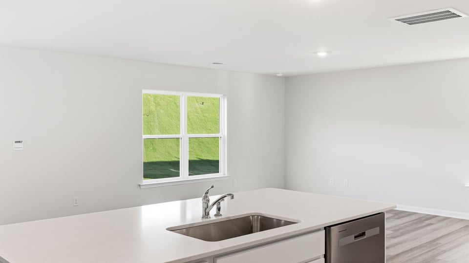 Kitchen and island with quartz countertops.