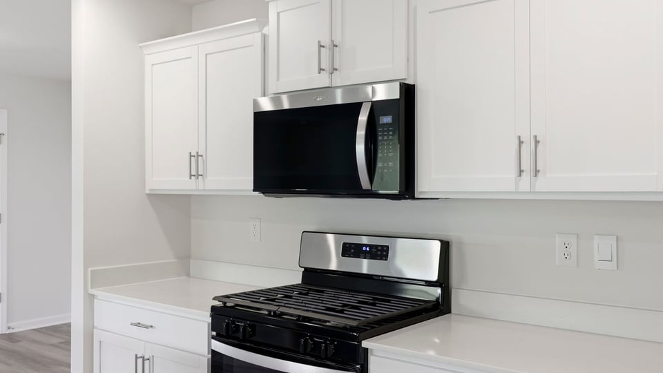 Kitchen and island with quartz countertops.