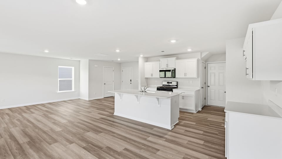 Kitchen and island with quartz countertops.