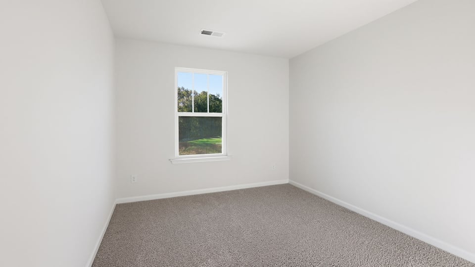 Bedroom with carpet and window.