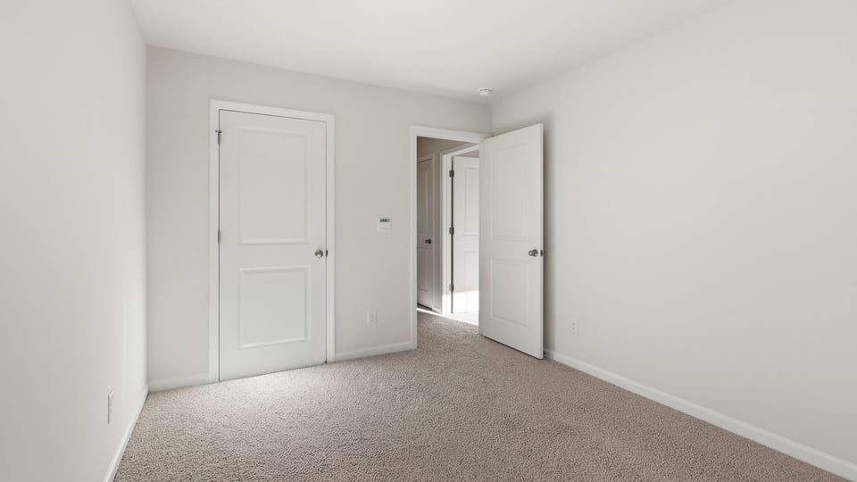 Bedroom with carpet and window.
