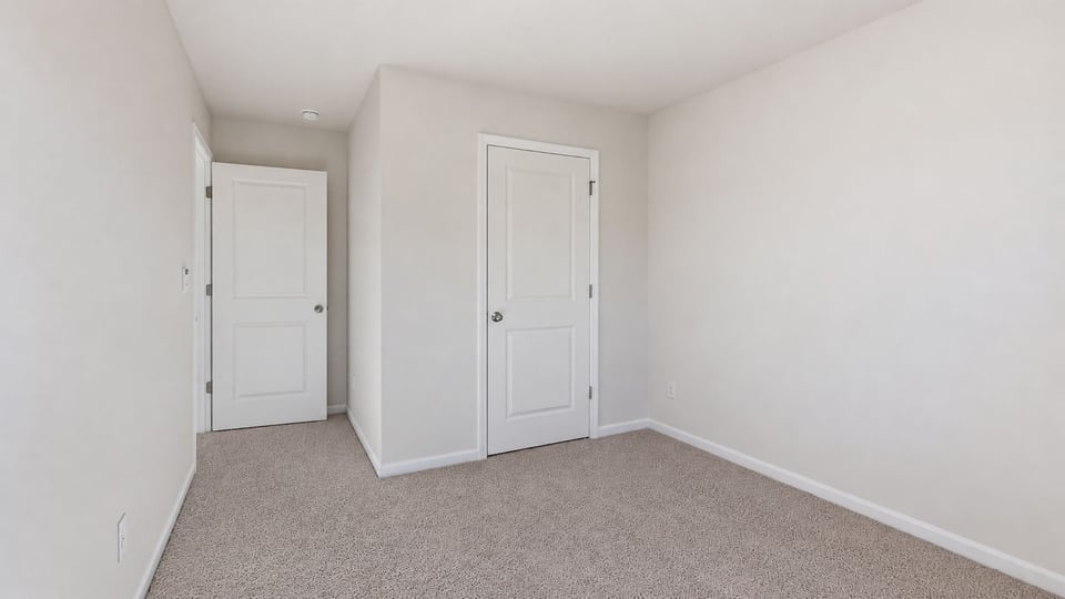 Bedroom with carpet and window.