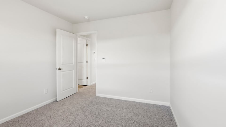Bedroom with carpet and window.
