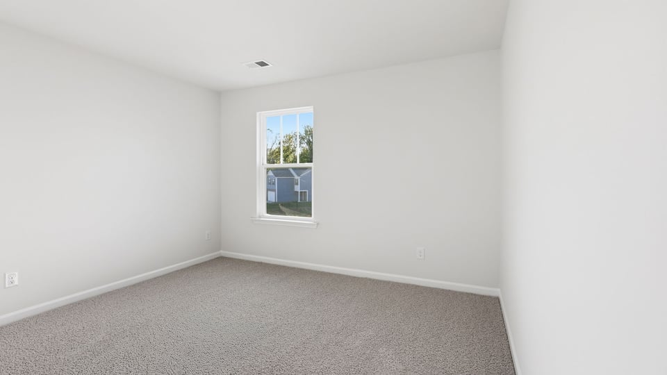 Bedroom with carpet and window.