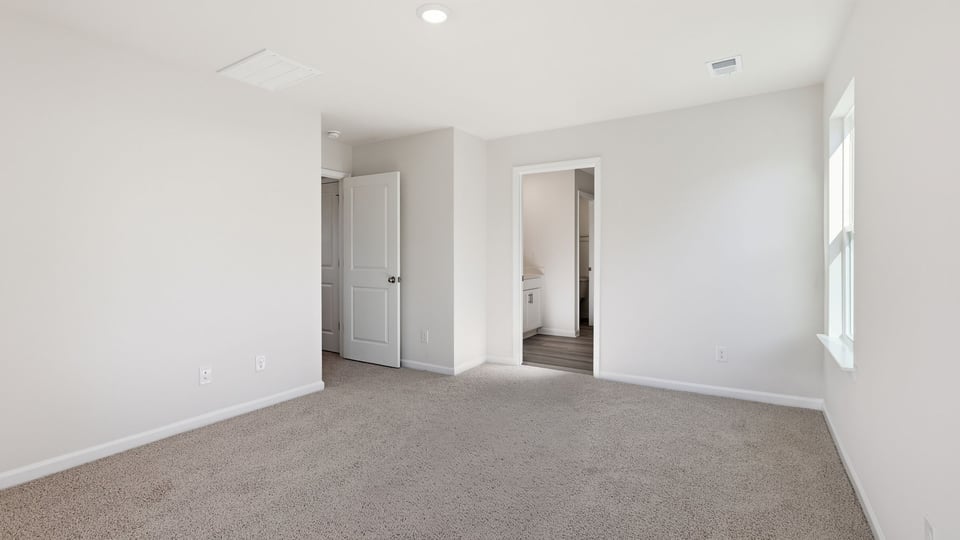 Bedroom with carpet and window.