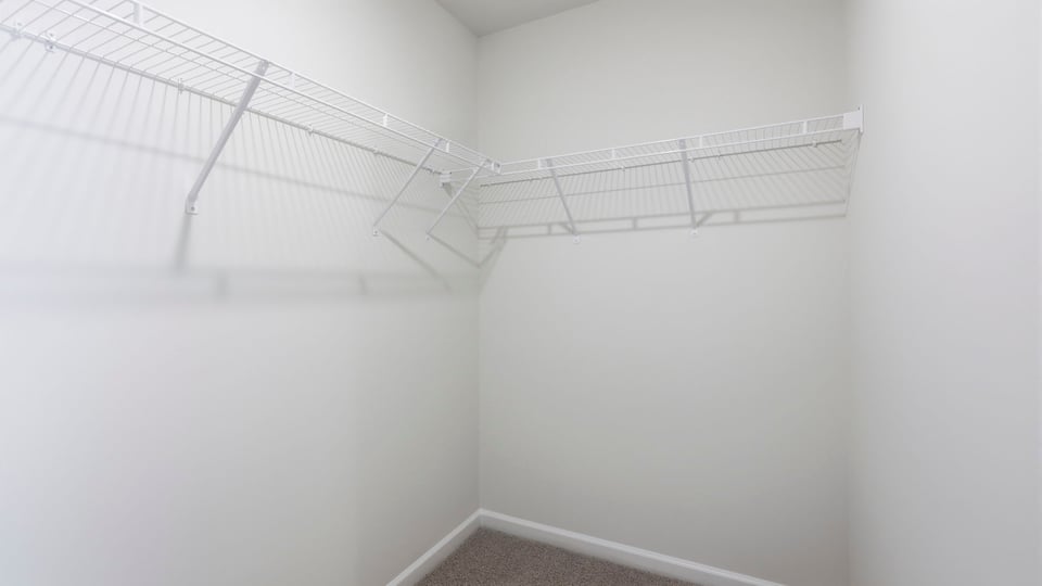 Closet with hanging storage racks.