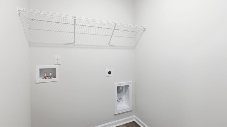 Laundry room with hanging storage racks.
