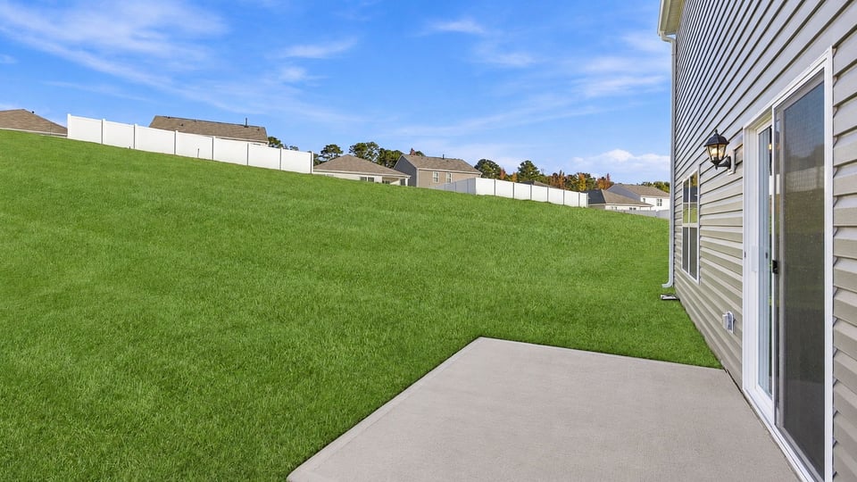 Back exterior of home with patio.