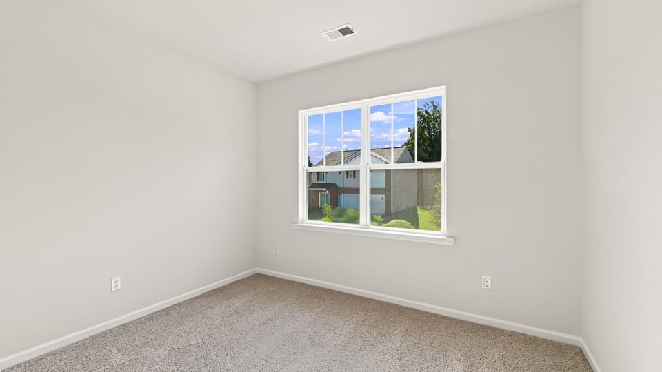 Bedroom with carpet and window.a