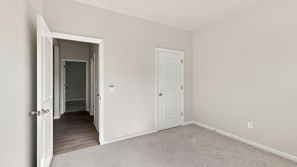 Bedroom with carpet and window.