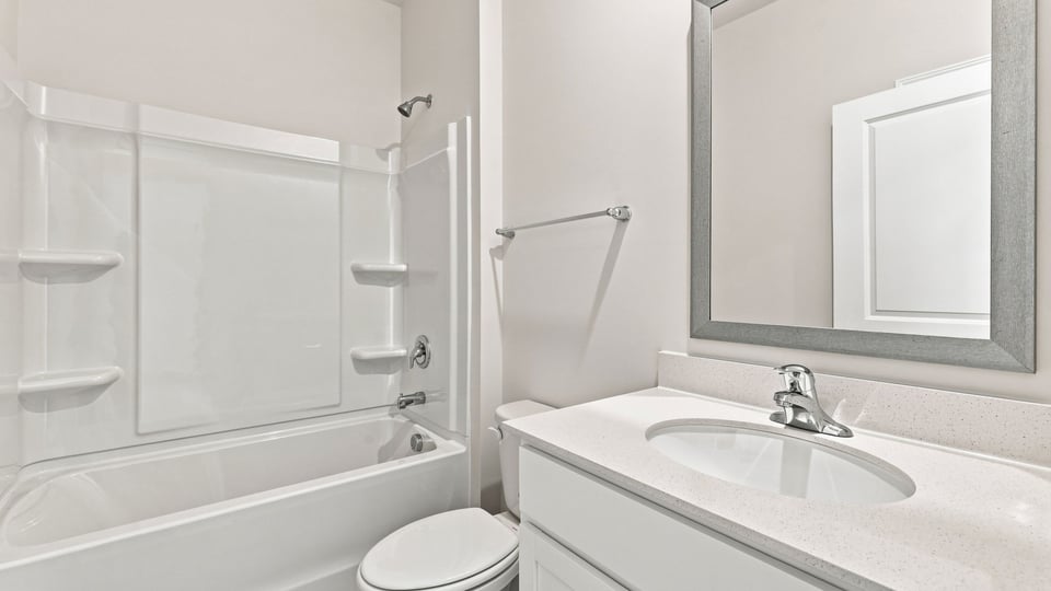 Bathroom with single vanity sink and bathtub.