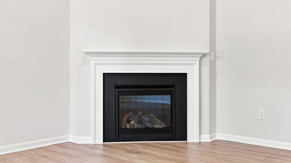 Living room with windows and fireplace.