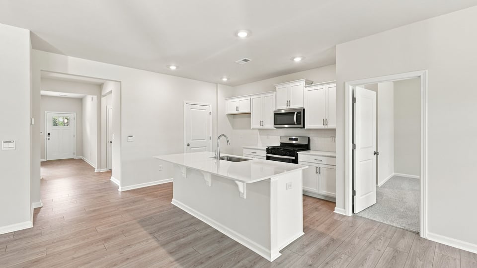 Kitchen and island with quartz countertops.