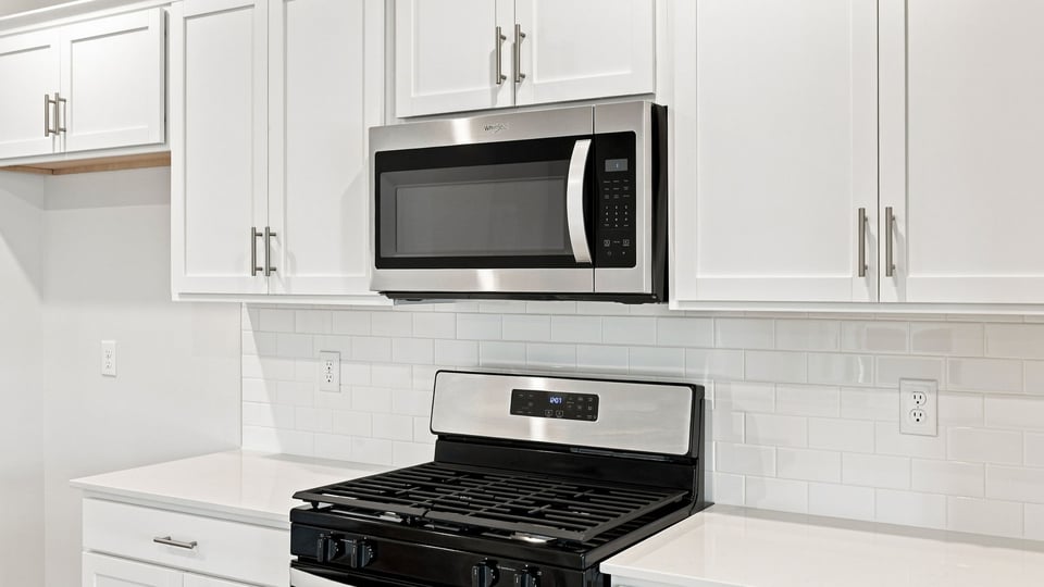 Kitchen and island with quartz countertops.
