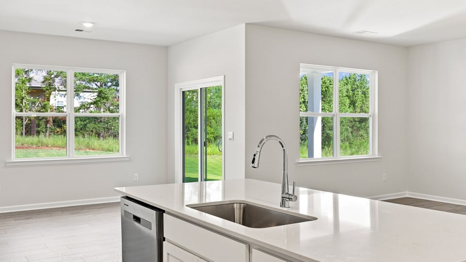 Kitchen and island with quartz countertops.