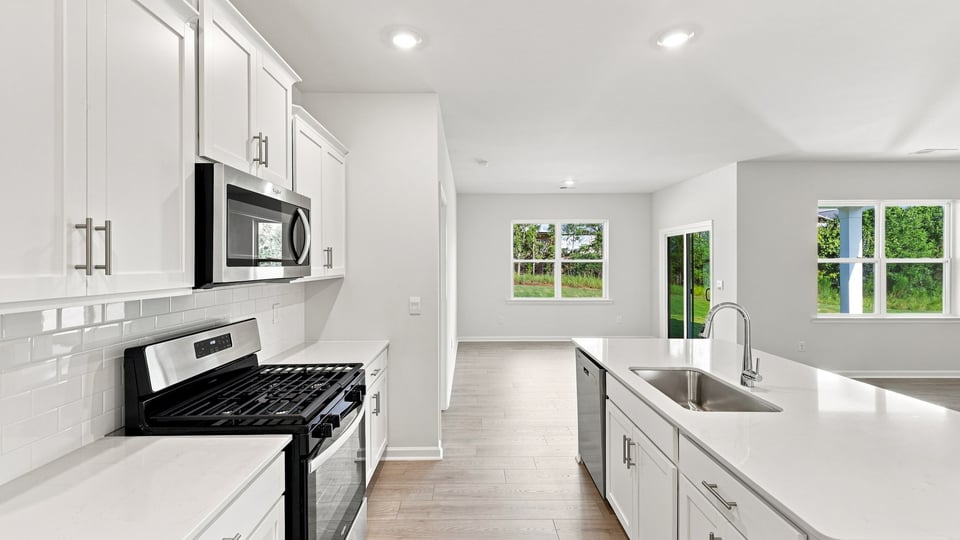 Kitchen and island with quartz countertops.