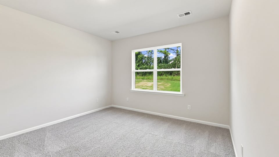 Bedroom with carpet and window.