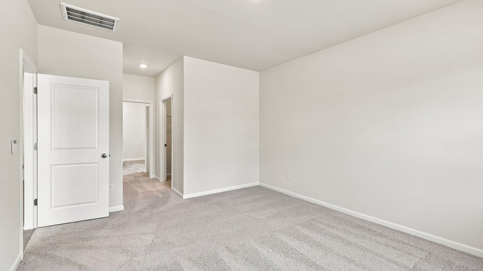 Bedroom with carpet and window.