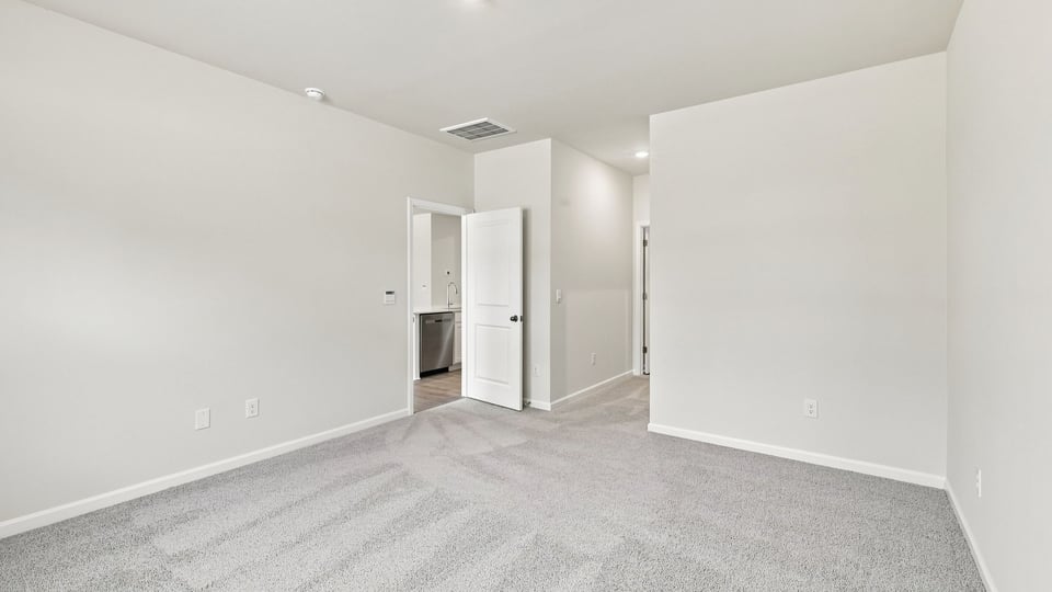 Bedroom with carpet and window.
