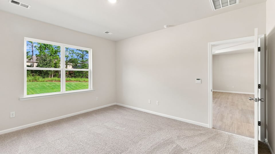 Bedroom with carpet and window.