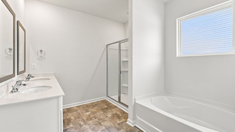 Bathroom with bathtub and walk in shower.