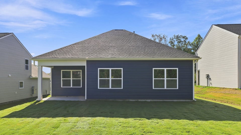 Back exterior of home with large backyard.