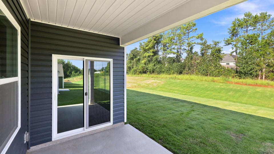 Back exterior of home with patio.