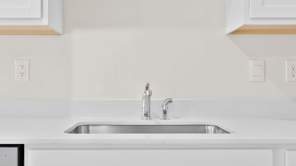 Kitchen with cabinets and window.