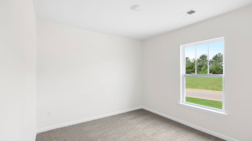 Bedroom with window and carpet.
