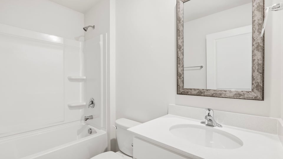 Bathroom with single vanity sink and bathtub.
