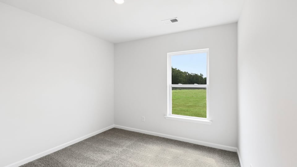 Bedroom with window and carpet.