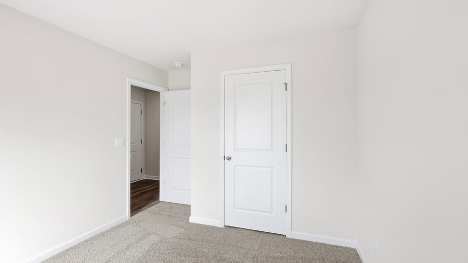 Bedroom with window and carpet.