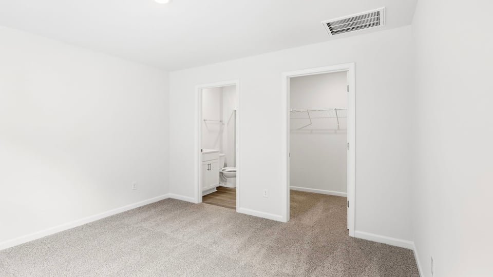 Bedroom with carpet and windows.