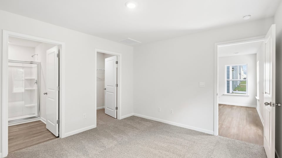 Bedroom with carpet and windows.