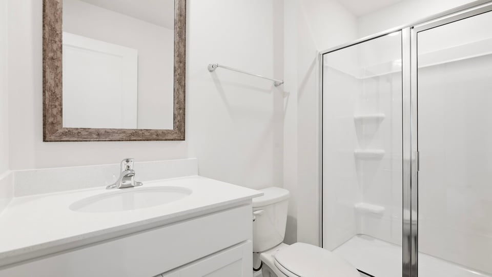 Bathroom with single vanity sink and walk in shower.