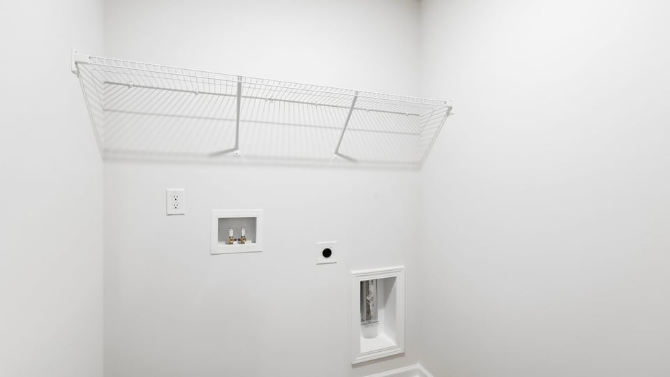 Laundry room with hanging storage racks.