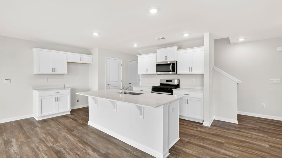 Kitchen with island and cabinets.