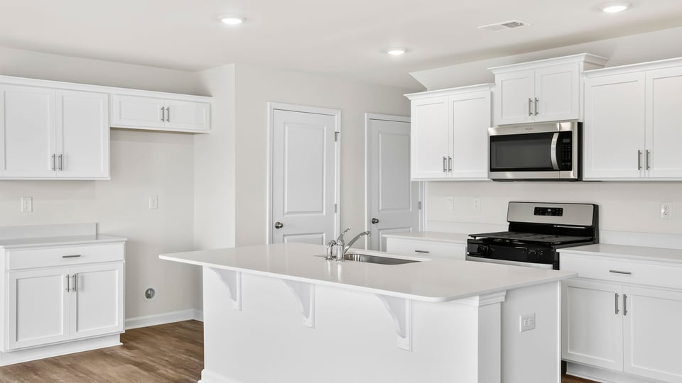 Kitchen with island and cabinets.