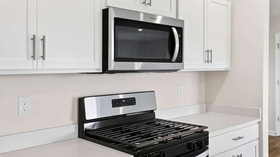 Kitchen with island and cabinets.